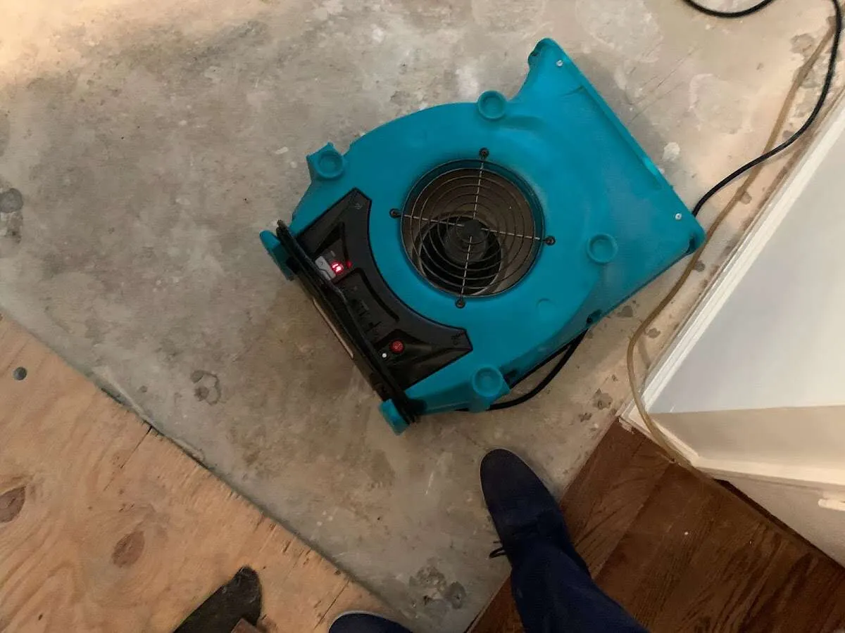 Air mover drying subfloor during Commercial Water Damage Restoration in Barrington